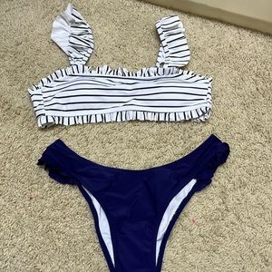 NWT- size s- top has black and white stripes and bottom are navy-
